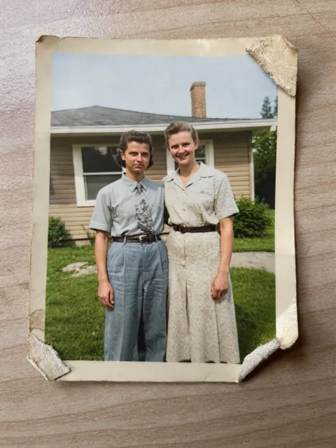 The same snapshot in color, with the scratches and spots gone; the torn border of the print remains.